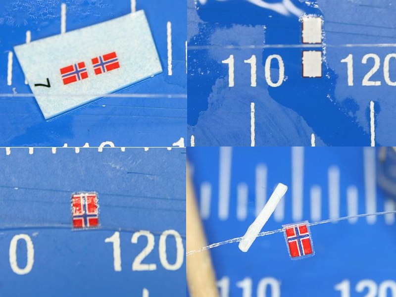 Die Flagge fehlt noch. <br />Ausschneiden, ablösen, umdrehen, auf einen Nylonfaden klappen und ein Stück vom Radar als Fahnenmast ankleben. Fertig